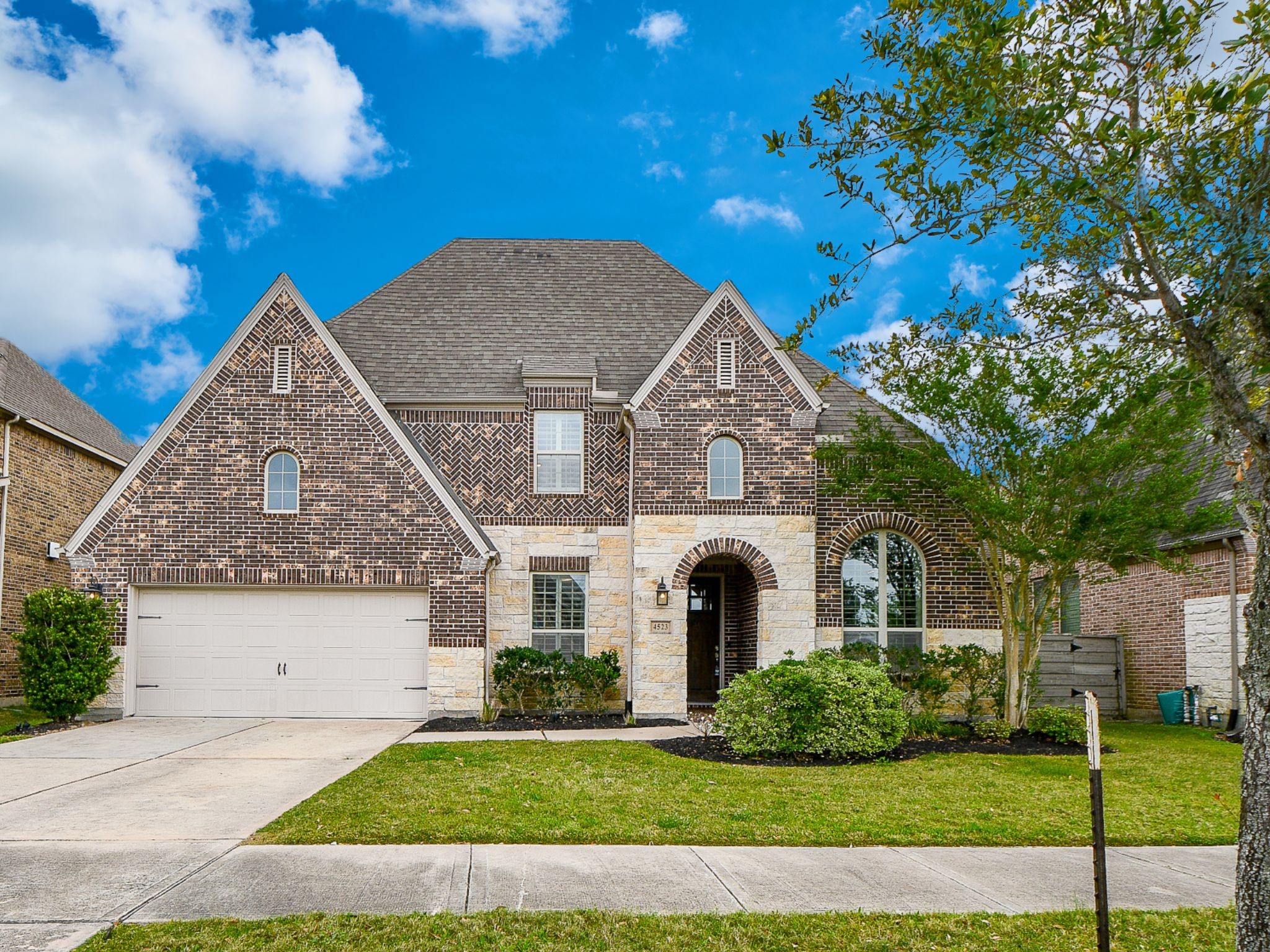 4523 Juniper Ridge Lane Manvel, TX 77578 - Photo 35 of 38 a view of a white house next to a yard with big trees