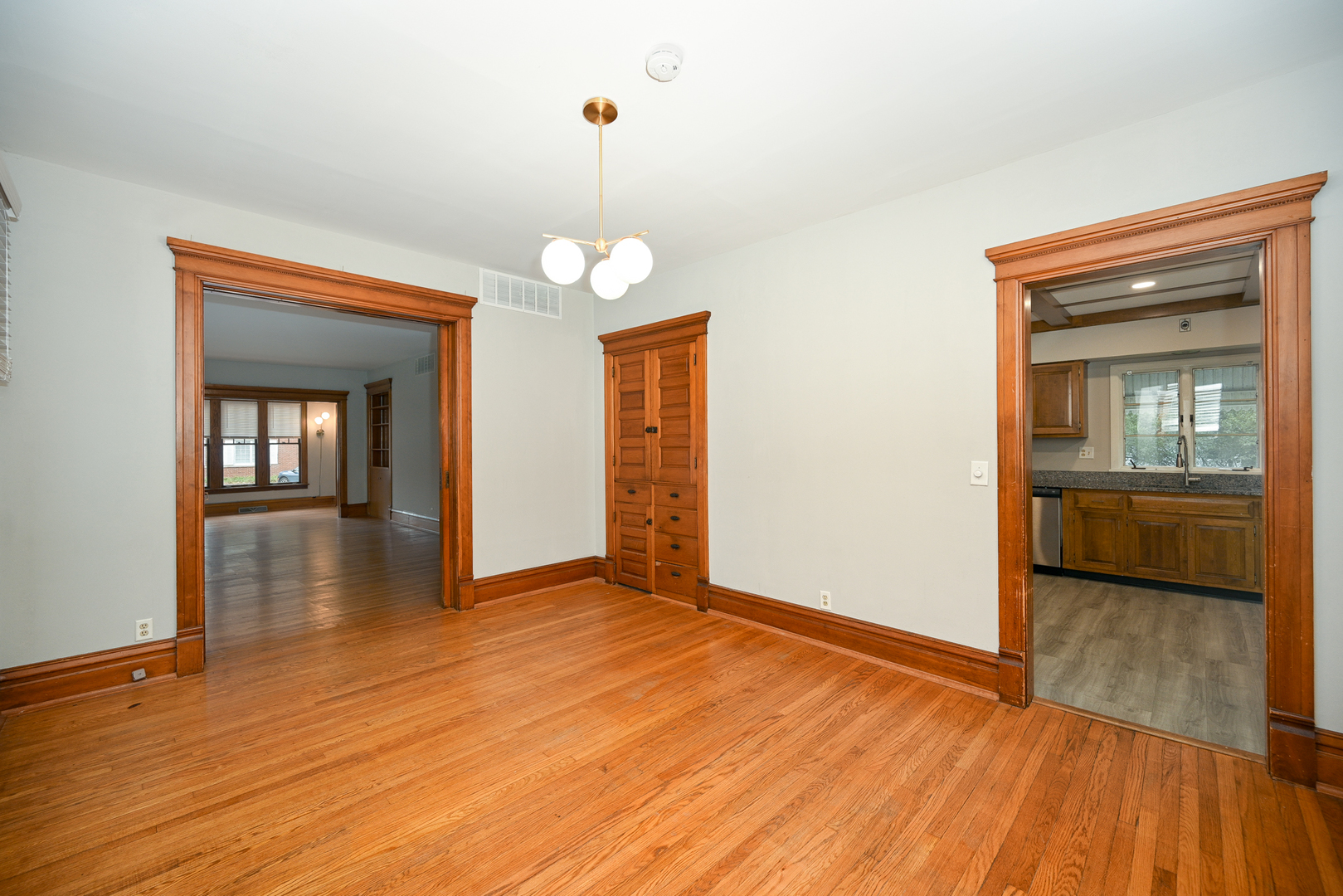 24021 Chicago Street Plainfield, IL 60544 - Photo 11 of 41 a view of a room with wooden floor staircase and a kitchen