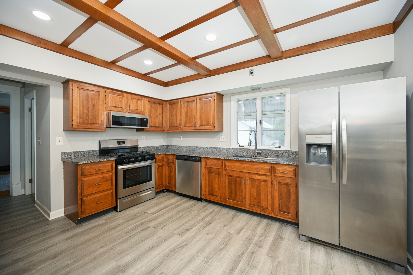 24021 Chicago Street Plainfield, IL 60544 - Photo 12 of 41 a kitchen with stainless steel appliances granite countertop a refrigerator a stove top oven a sink and dishwasher with wooden floor