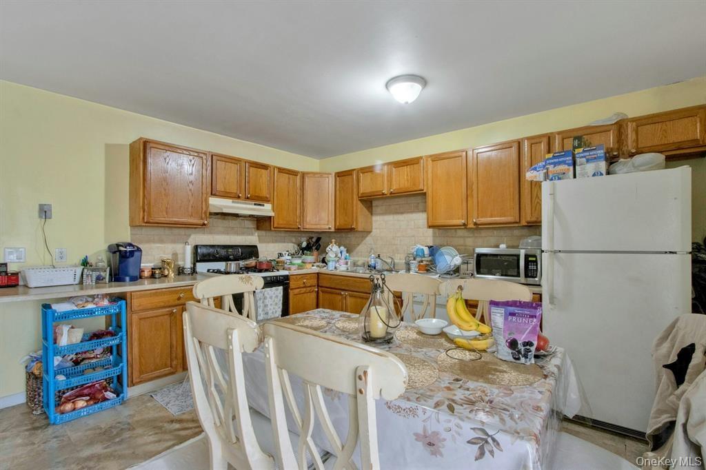 2740 South Road, Unit G11 Poughkeepsie, NY 12601 - Photo 11 of 14 a kitchen with stainless steel appliances granite countertop a refrigerator stove top oven a sink and dishwasher