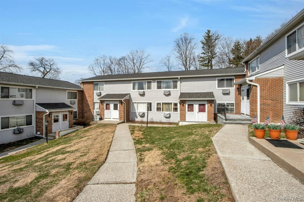 2740 South Road, Unit G11 Poughkeepsie, NY 12601 - Photo 13 of 14 a front view of a house with a yard outdoor seating and garage