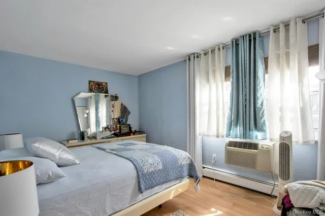 a bedroom with a bed and large windows