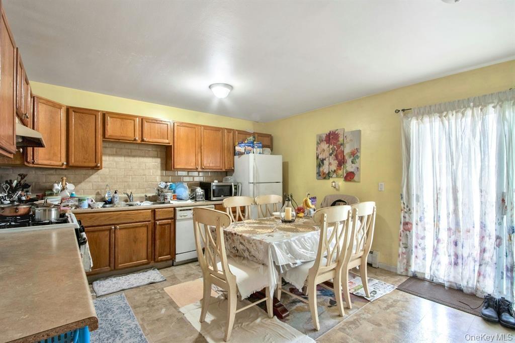 2740 South Road, Unit G11 Poughkeepsie, NY 12601 - Photo 10 of 14 a kitchen with stainless steel appliances kitchen island granite countertop a sink and cabinets