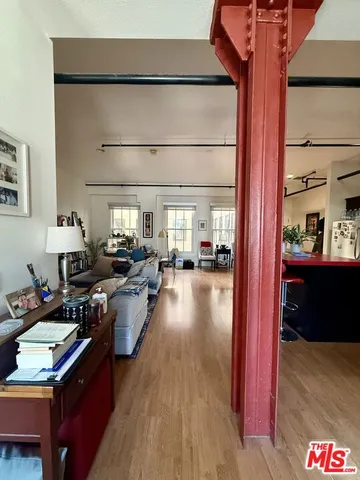 a bedroom with furniture and a large window