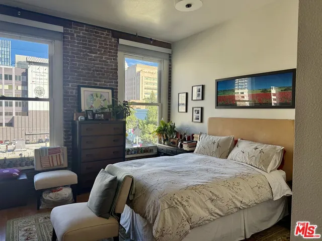 a view of a room with wooden floor and windows