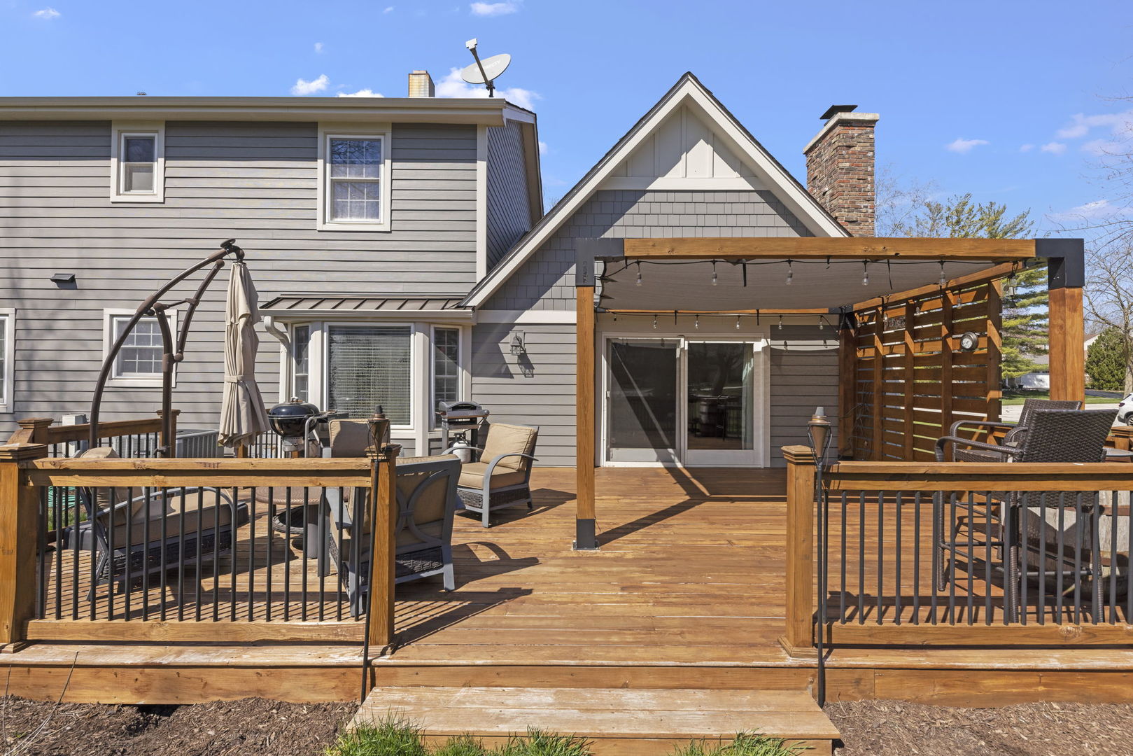 472 Sheffield Road Naperville, IL 60565 - Photo 32 of 47 a view of a house with wooden deck and furniture