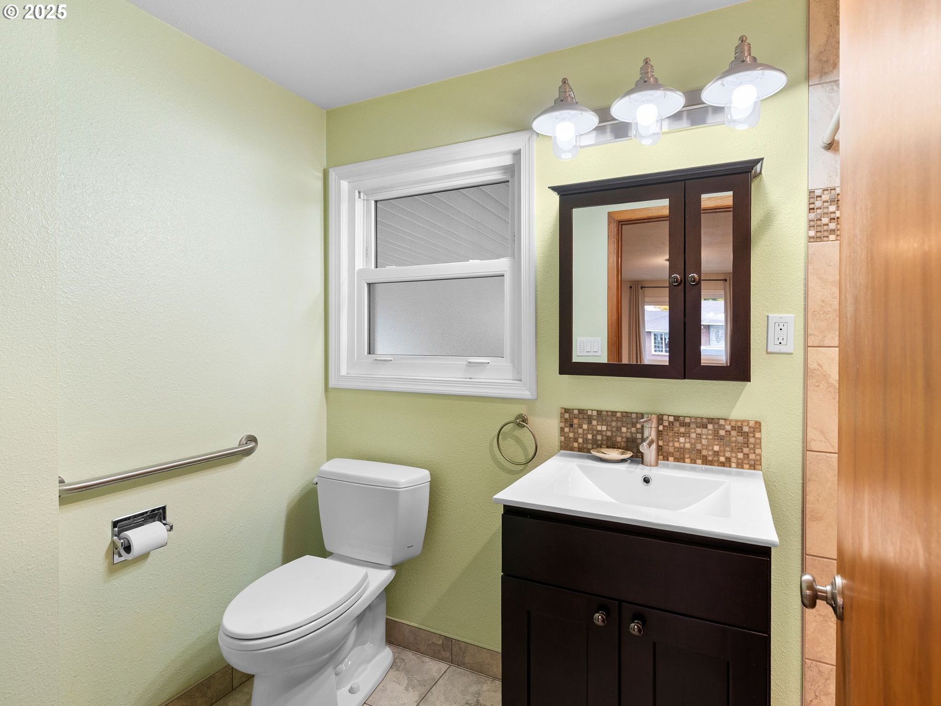 426 Northeast 116th Place Portland, OR 97220 - Photo 17 of 42 a bathroom with a toilet sink and mirror