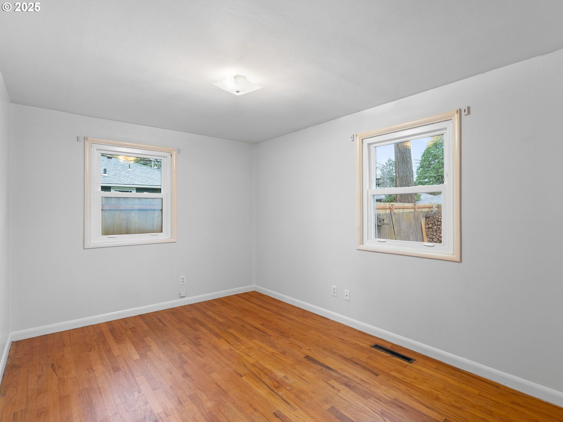 426 Northeast 116th Place Portland, OR 97220 - Photo 21 of 42 a view of empty room with wooden floor and fan