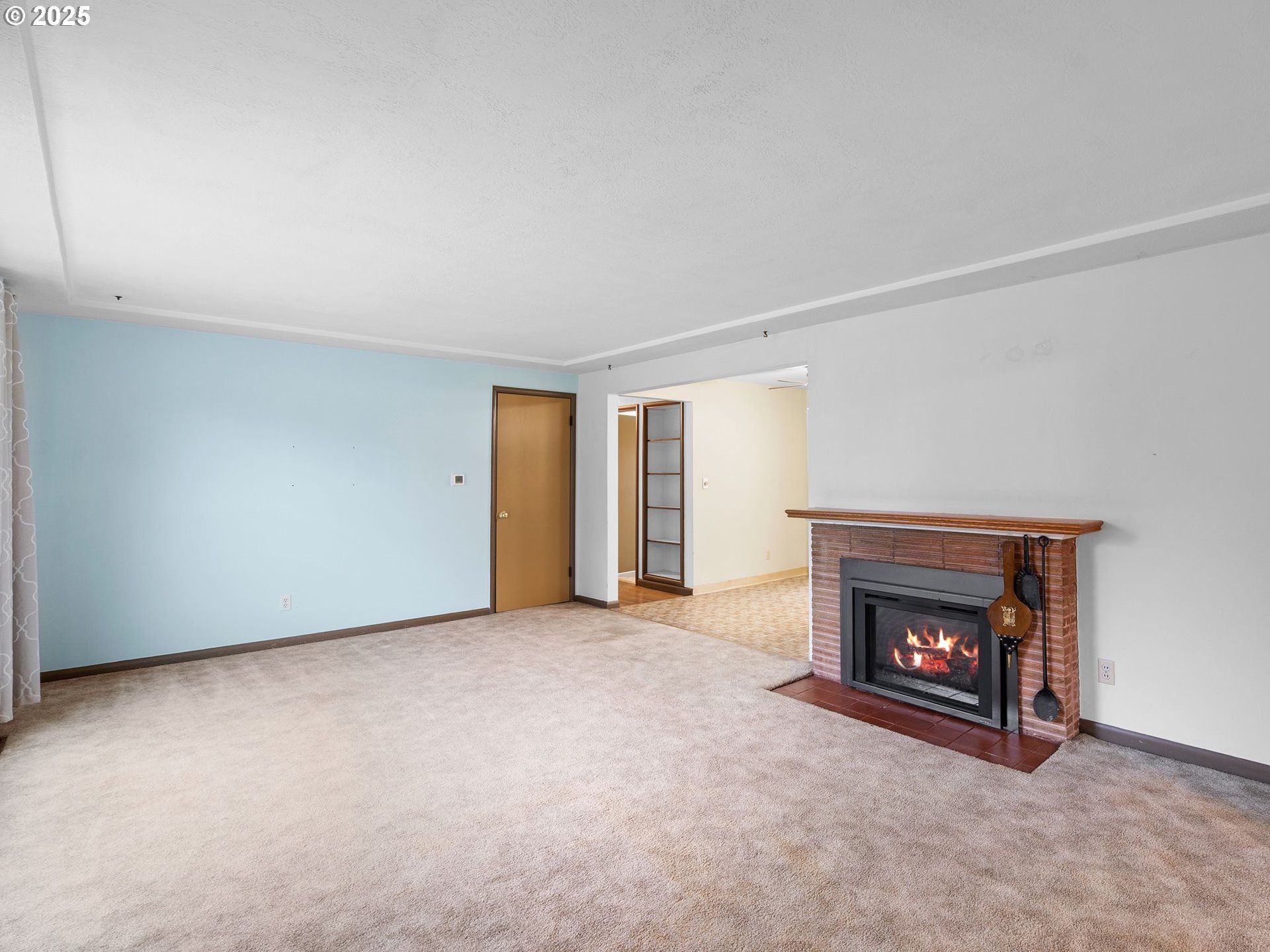 426 Northeast 116th Place Portland, OR 97220 - Photo 4 of 42 a view of an empty room with a fireplace and a window