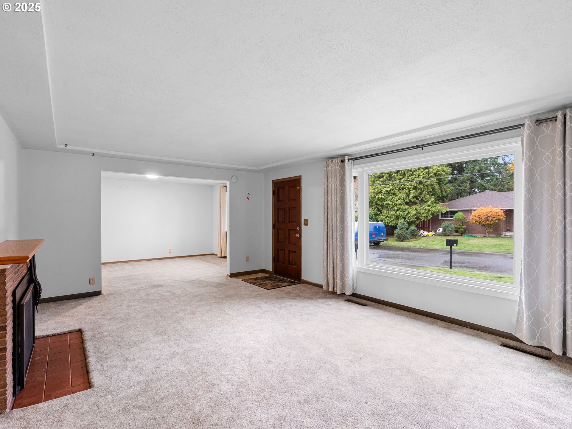 426 Northeast 116th Place Portland, OR 97220 - Photo 5 of 42 an empty room with floor to ceiling window and an outdoor view