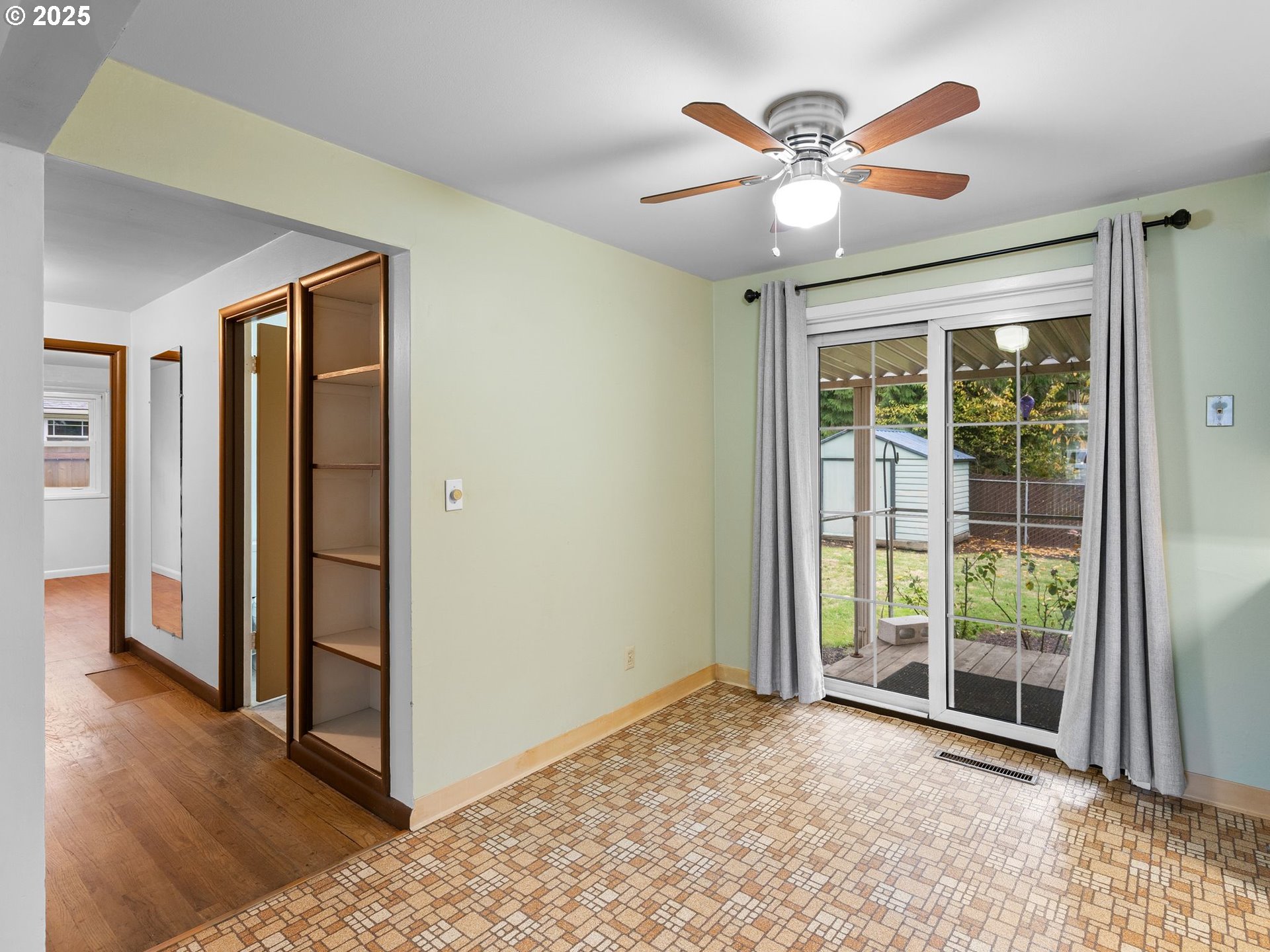 426 Northeast 116th Place Portland, OR 97220 - Photo 7 of 42 an empty room with ceiling fan and a large window
