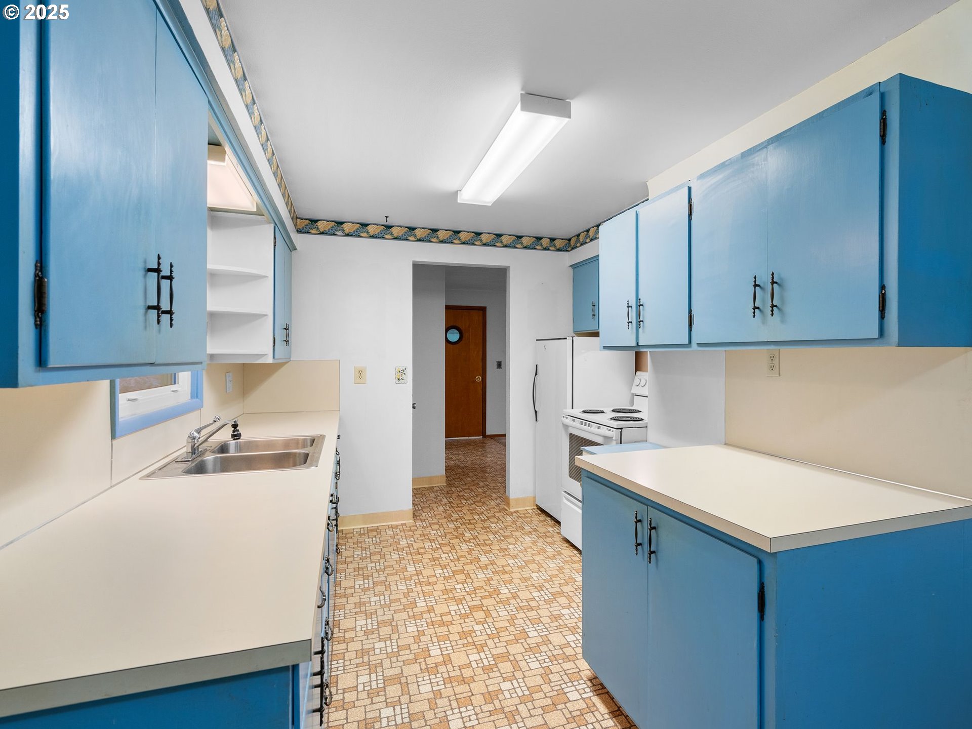 426 Northeast 116th Place Portland, OR 97220 - Photo 9 of 42 a kitchen with a sink a stove and refrigerator