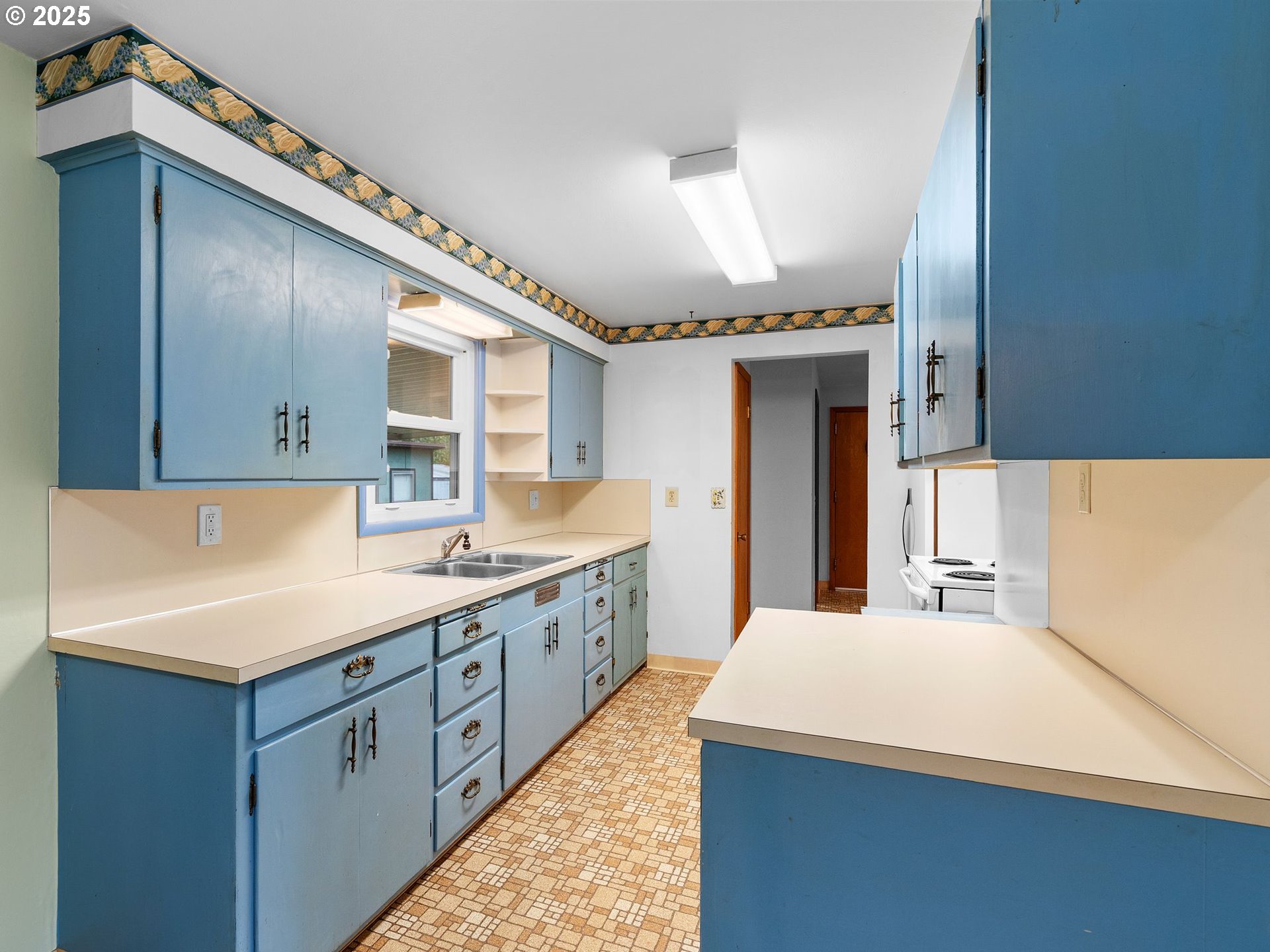 426 Northeast 116th Place Portland, OR 97220 - Photo 10 of 42 a kitchen with kitchen island a sink appliances and cabinets