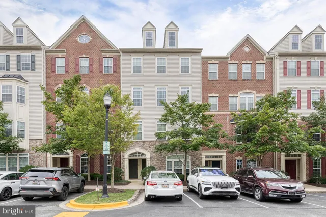 a view of a car parked in front of a brick house