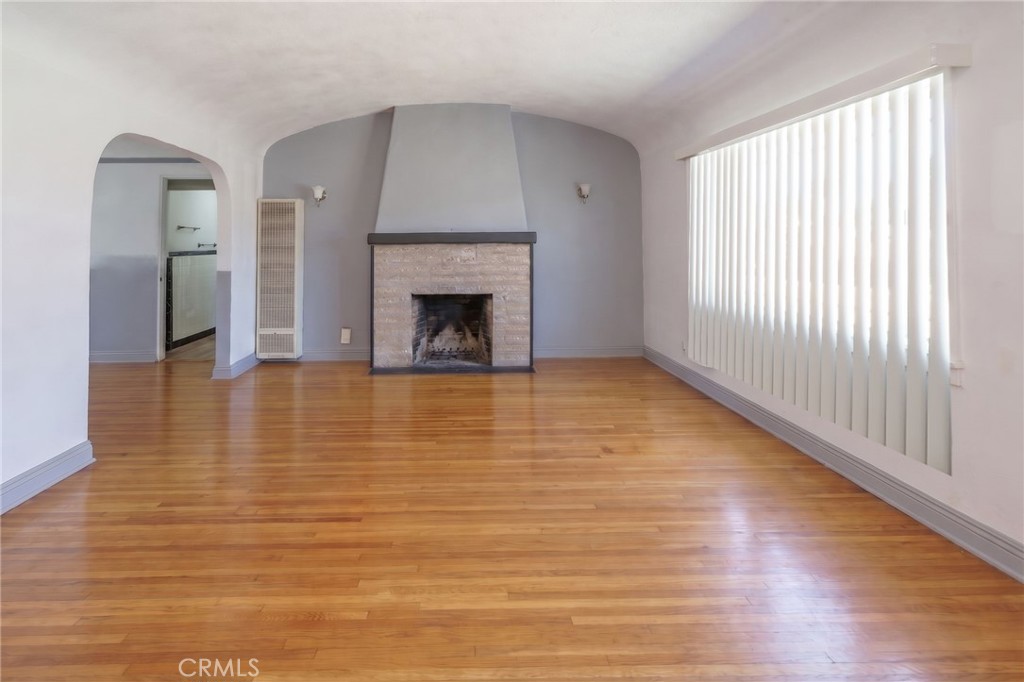 346 West School Street Compton, CA 90220 - Photo 13 of 29 a view of empty room with wooden floor and fireplace
