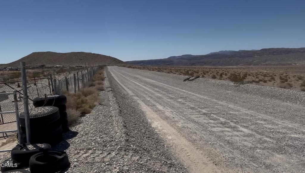 45101 Afton Road Baker, CA 92309 - Photo 20 of 38 a view of a dry yard with trees in the background
