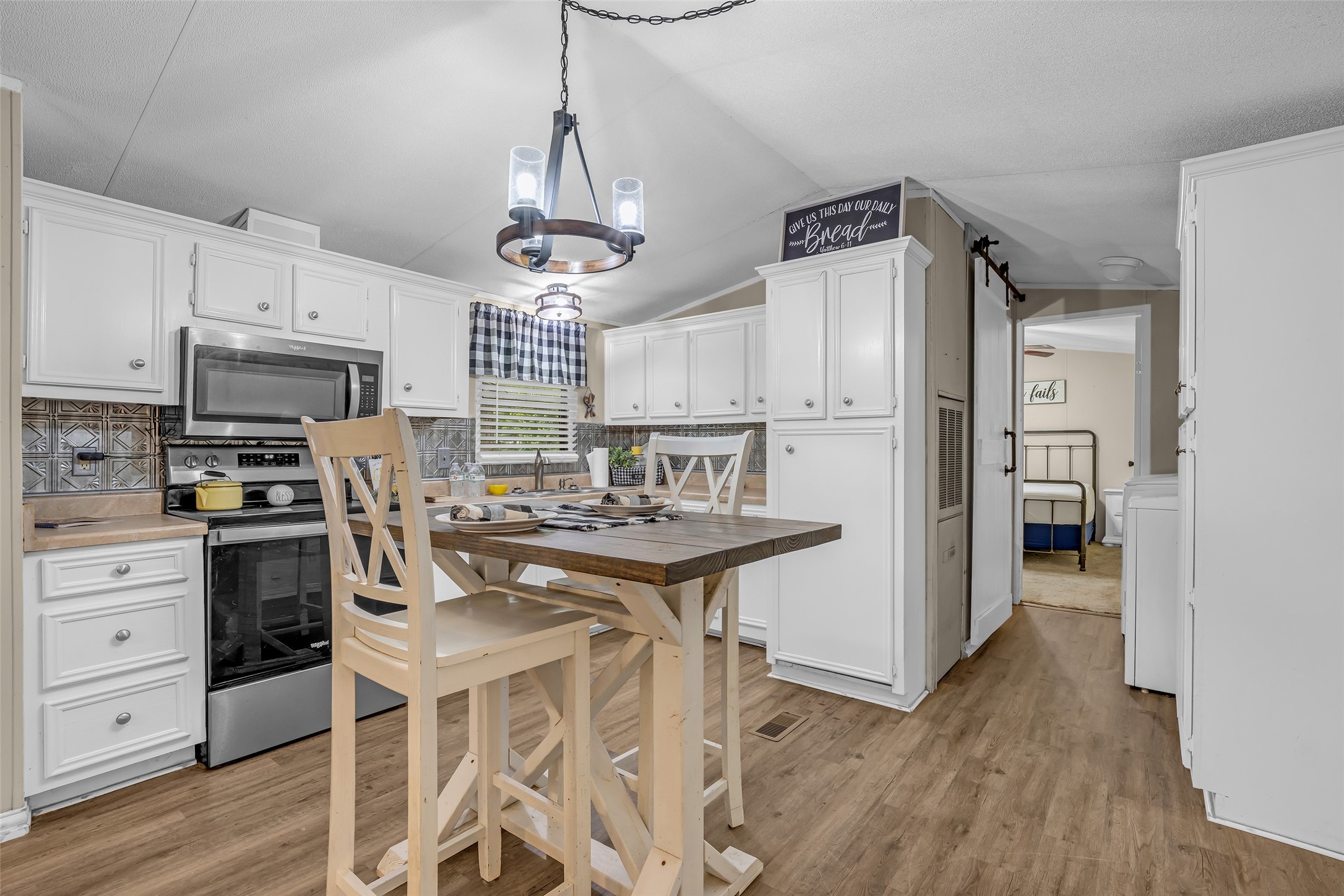 188 Chrissy Lane Trinity, TX 75862 - Photo 8 of 25 a kitchen with stainless steel appliances a stove a sink dishwasher a refrigerator and cabinets with wooden floor