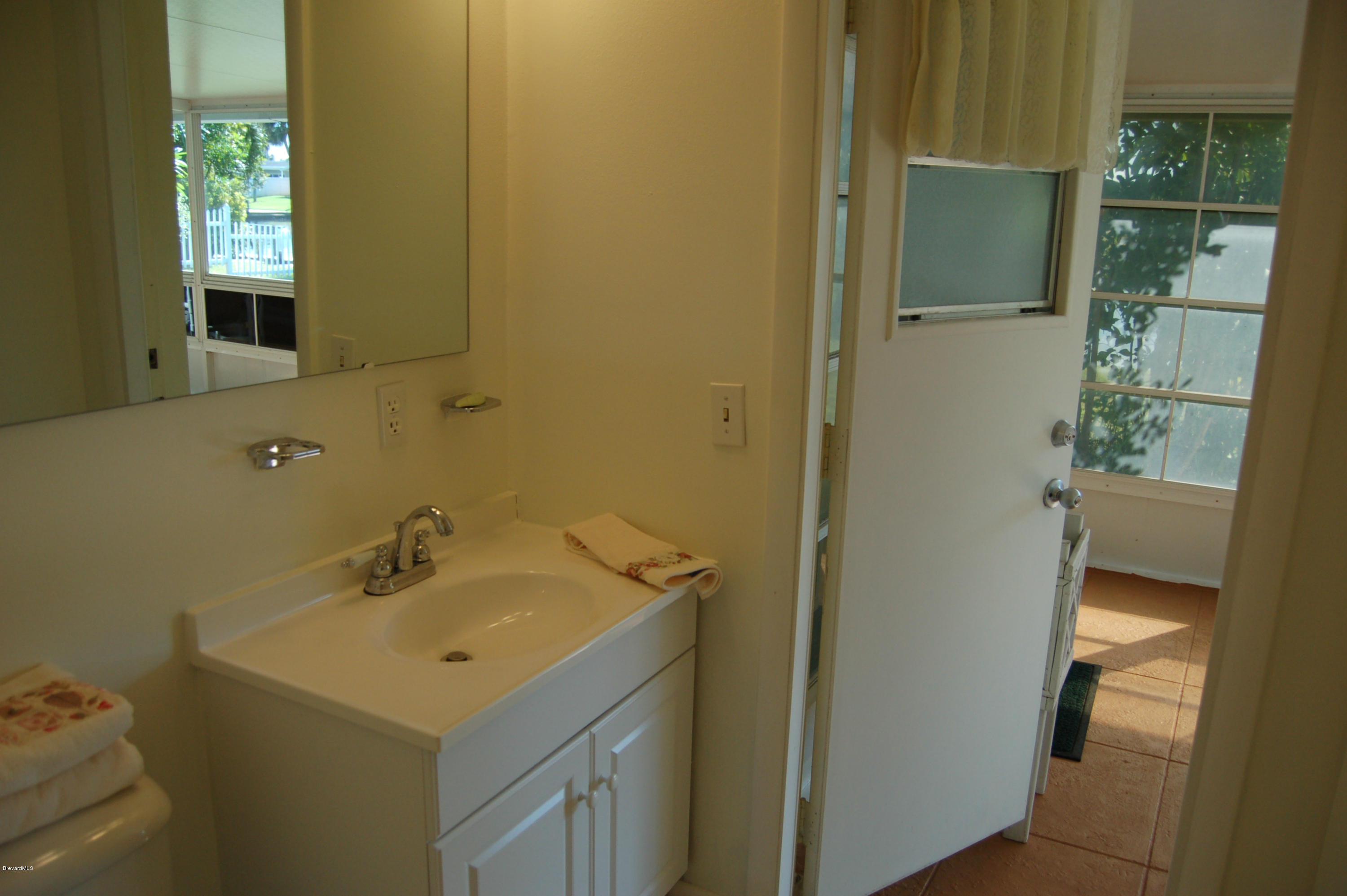113 La Riviere Road Cocoa Beach, FL 32931 - Photo 22 of 32 Hall bath leading to Porch