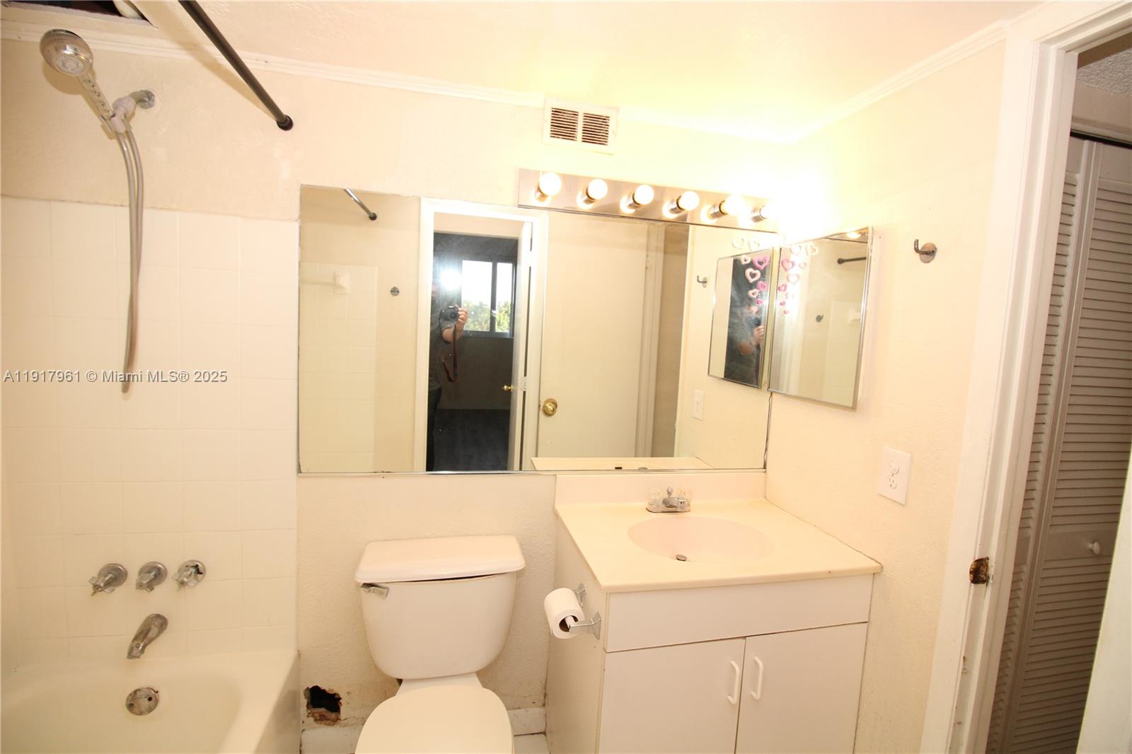 1251 Northeast 108th Street, Unit 312 North Miami, FL 33161 - Photo 6 of 11 a bathroom with a sink a toilet and shower