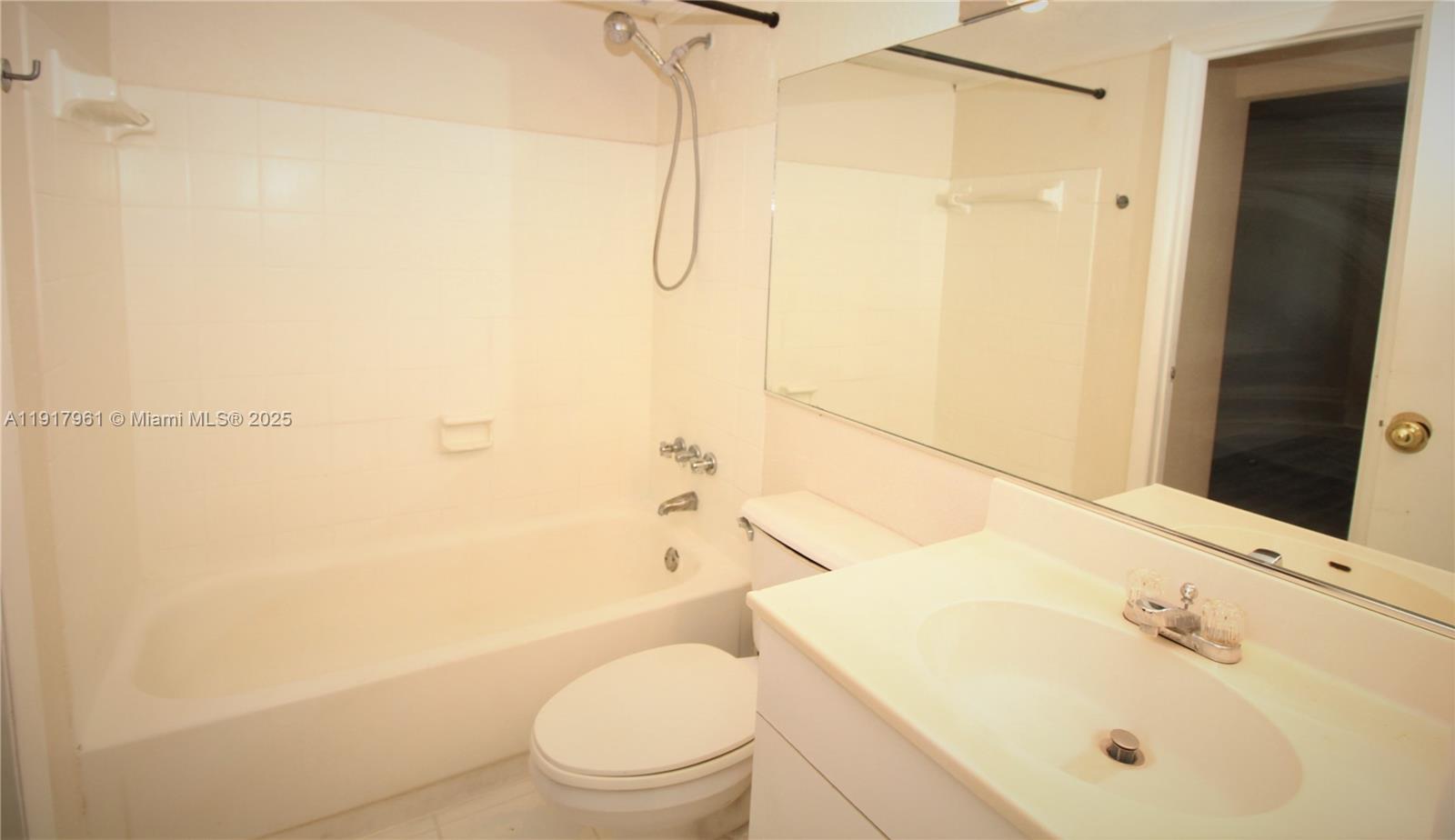 1251 Northeast 108th Street, Unit 312 North Miami, FL 33161 - Photo 7 of 11 a bathroom with a sink toilet and shower