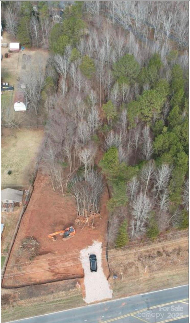a view of a yard with large trees