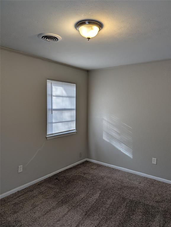 6324 Regal Road Forest Hill, TX 76119 - Photo 17 of 24 Spare room featuring a textured ceiling and carpet floors