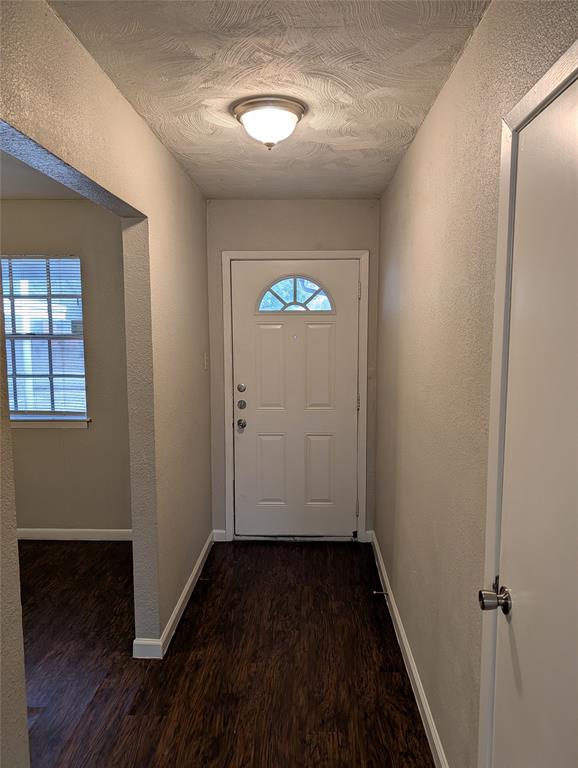 6324 Regal Road Forest Hill, TX 76119 - Photo 4 of 24 Entryway featuring a textured wall, wood finished floors, and a textured ceiling