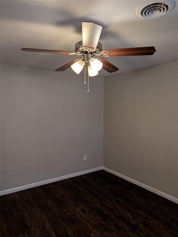 6324 Regal Road Forest Hill, TX 76119 - Photo 5 of 24 Unfurnished room featuring a ceiling fan and dark wood-type flooring