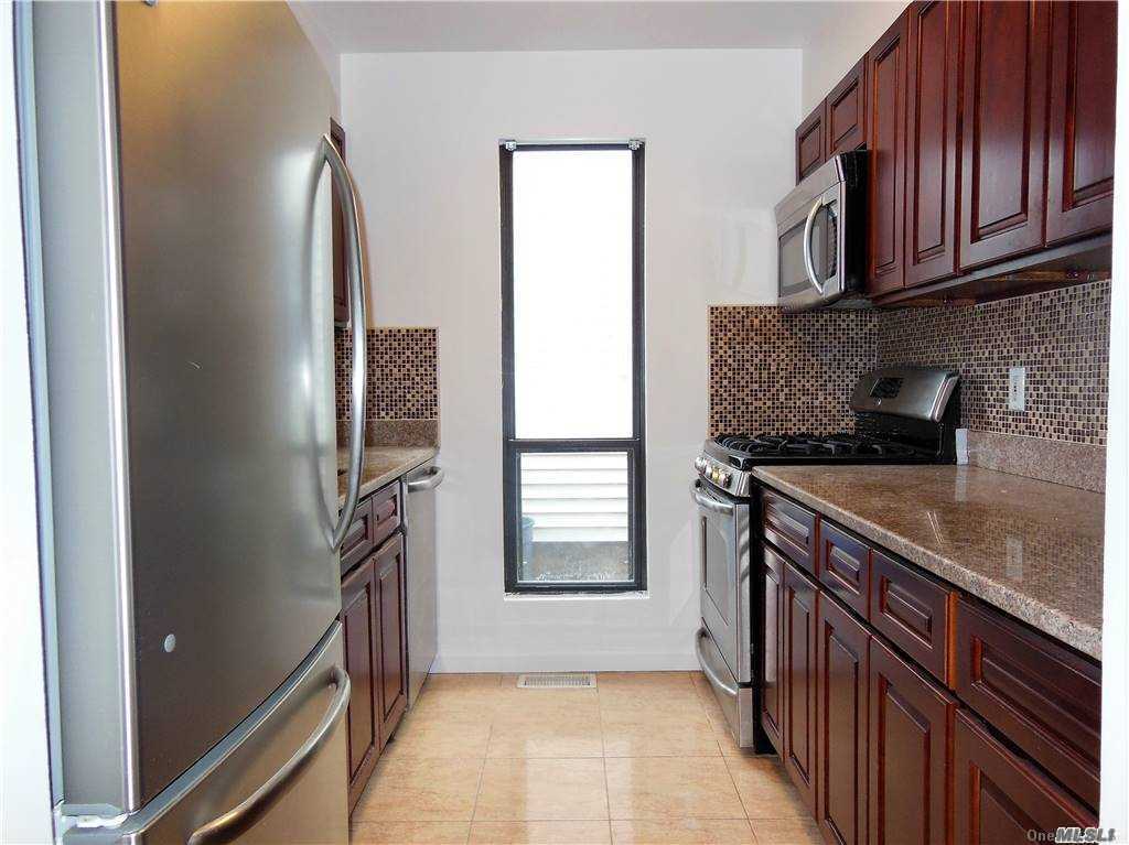 a kitchen with stainless steel appliances granite countertop a refrigerator a sink and dishwasher