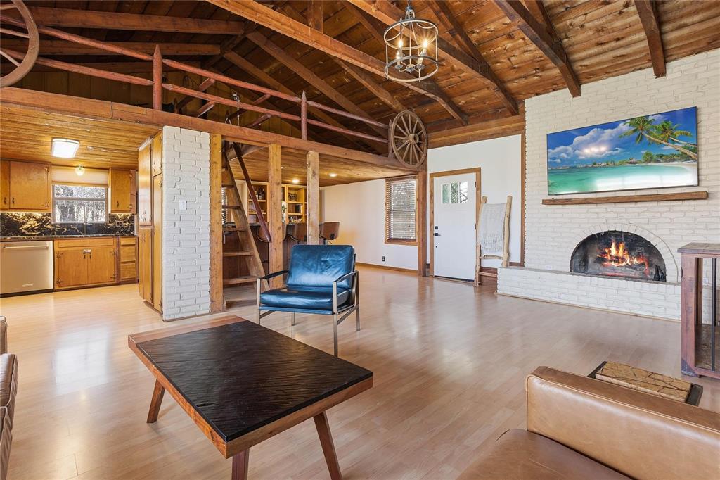 9213 Wilson Road Pilot Point, TX 76258 - Photo 7 of 36 Exposed wood-beam ceilings and light wood-finish flooring define this open living space