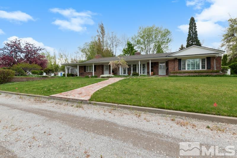 a front view of a house with a garden