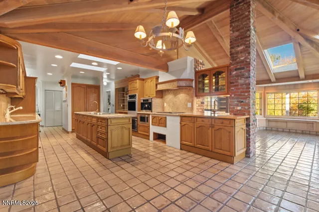 a bathroom with a sink a toilet a mirror and shower