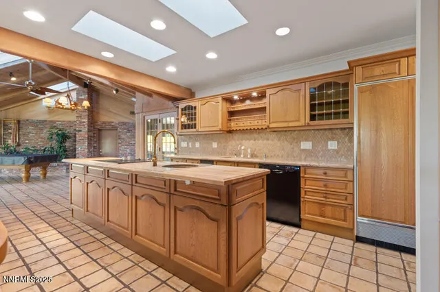a view of a backyard with table and chairs and a tree