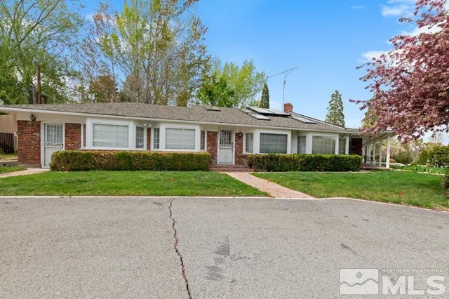 a dining room with furniture potted plants and wooden floor