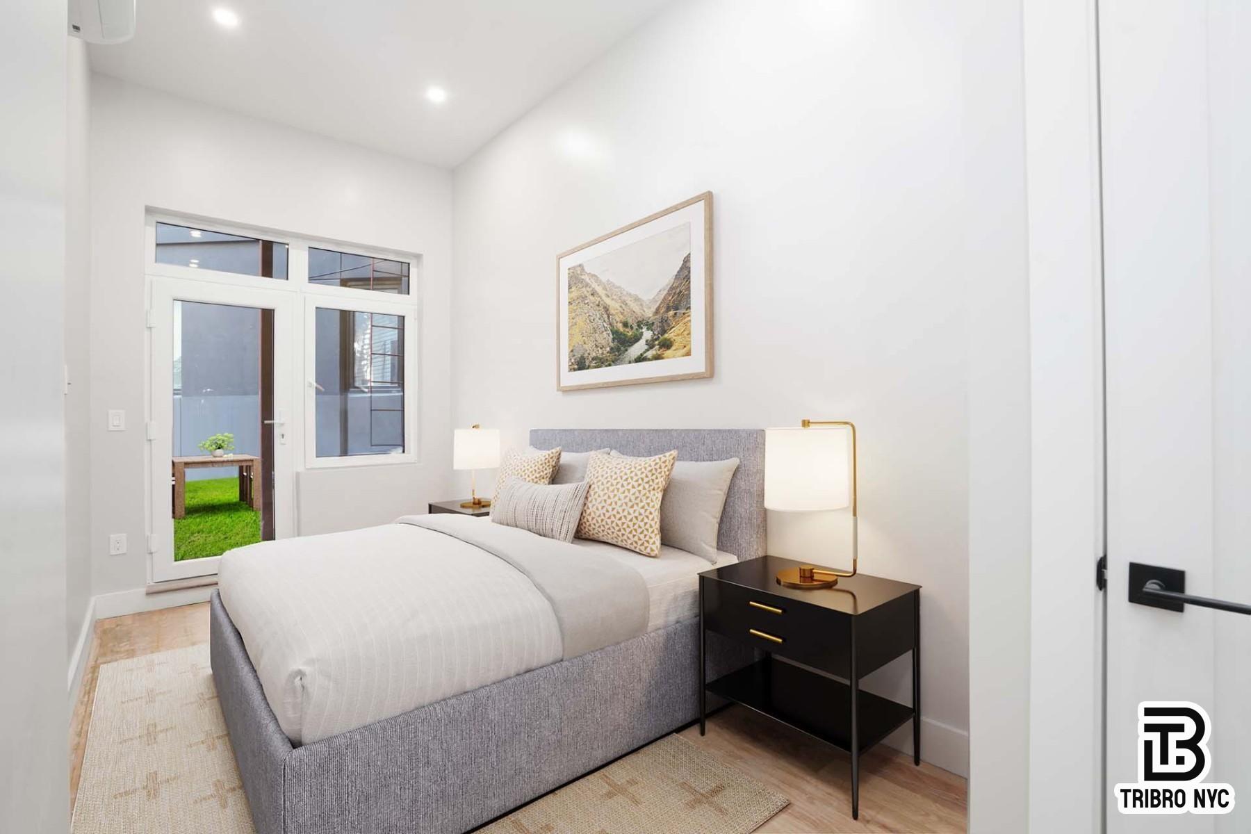 850 Flushing Avenue, Unit 1R Brooklyn, NY 11206 - Photo 2 of 10 a bedroom with a bed and a painting on the wall