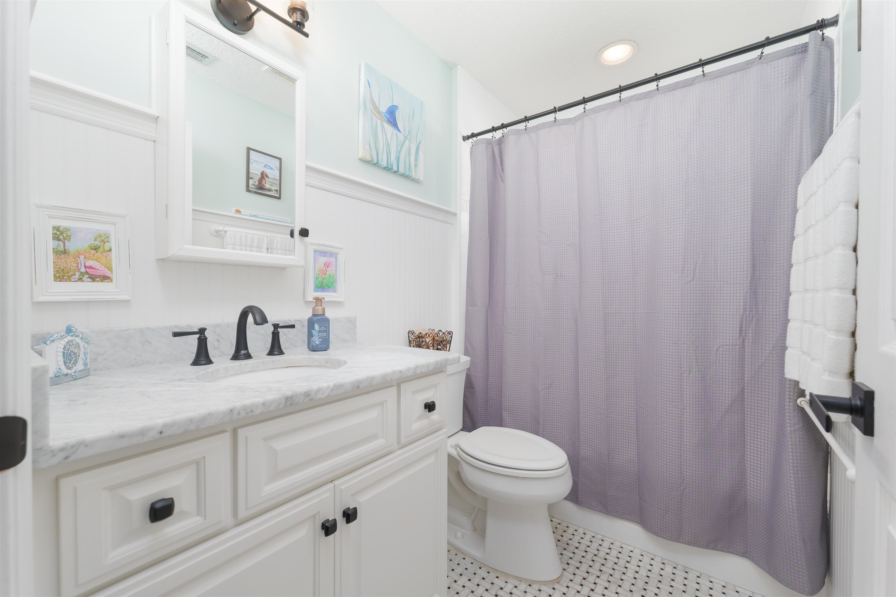 5324 5th Street St. Augustine, FL 32080 - Photo 41 of 45 a bathroom with a sink a toilet and a mirror