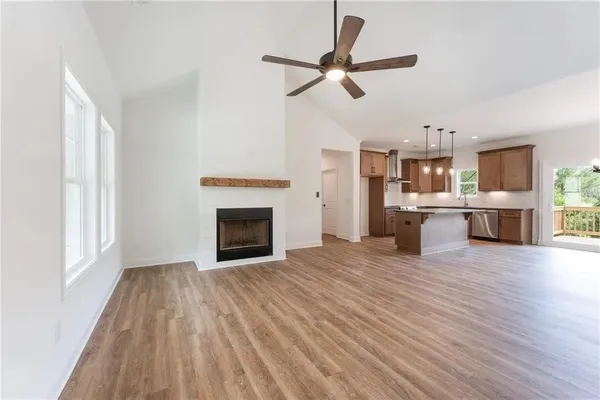 a view of a room with kitchen appliances wooden floor and a window