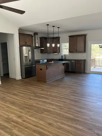 a kitchen with stainless steel appliances wooden cabinets a refrigerator and a stove