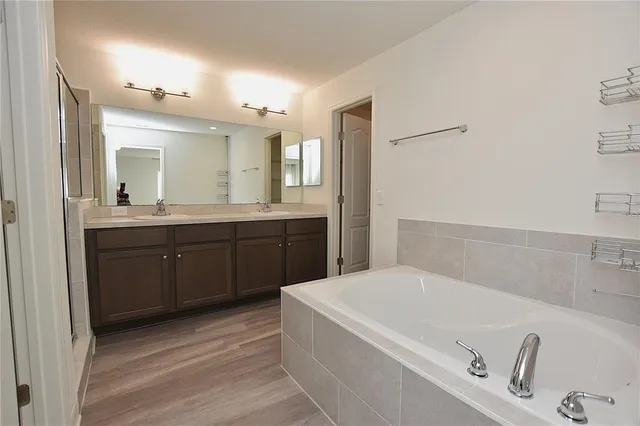 a bathroom with a sink a mirror and a shower