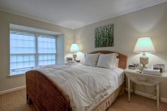 a bedroom with a bed and a lamp