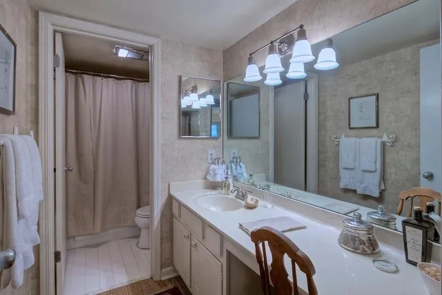 a bathroom with a double vanity sink a mirror and a shower