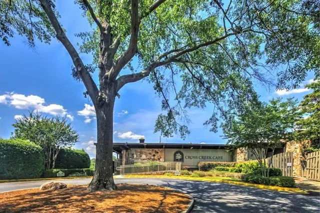 a view of swimming pool with large tree