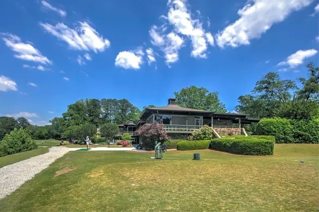 a view of a house with swimming pool yard fire pit and outdoor seating