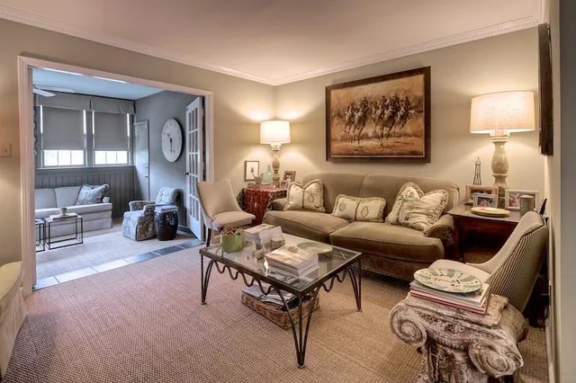 a living room with furniture a rug and a lamp