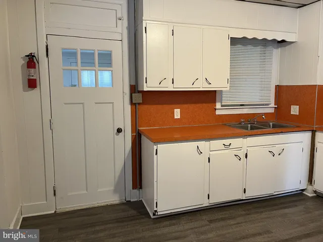 a view of a kitchen with wooden floor