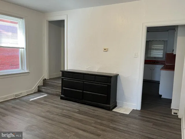 a room with a hardwood wall and a window