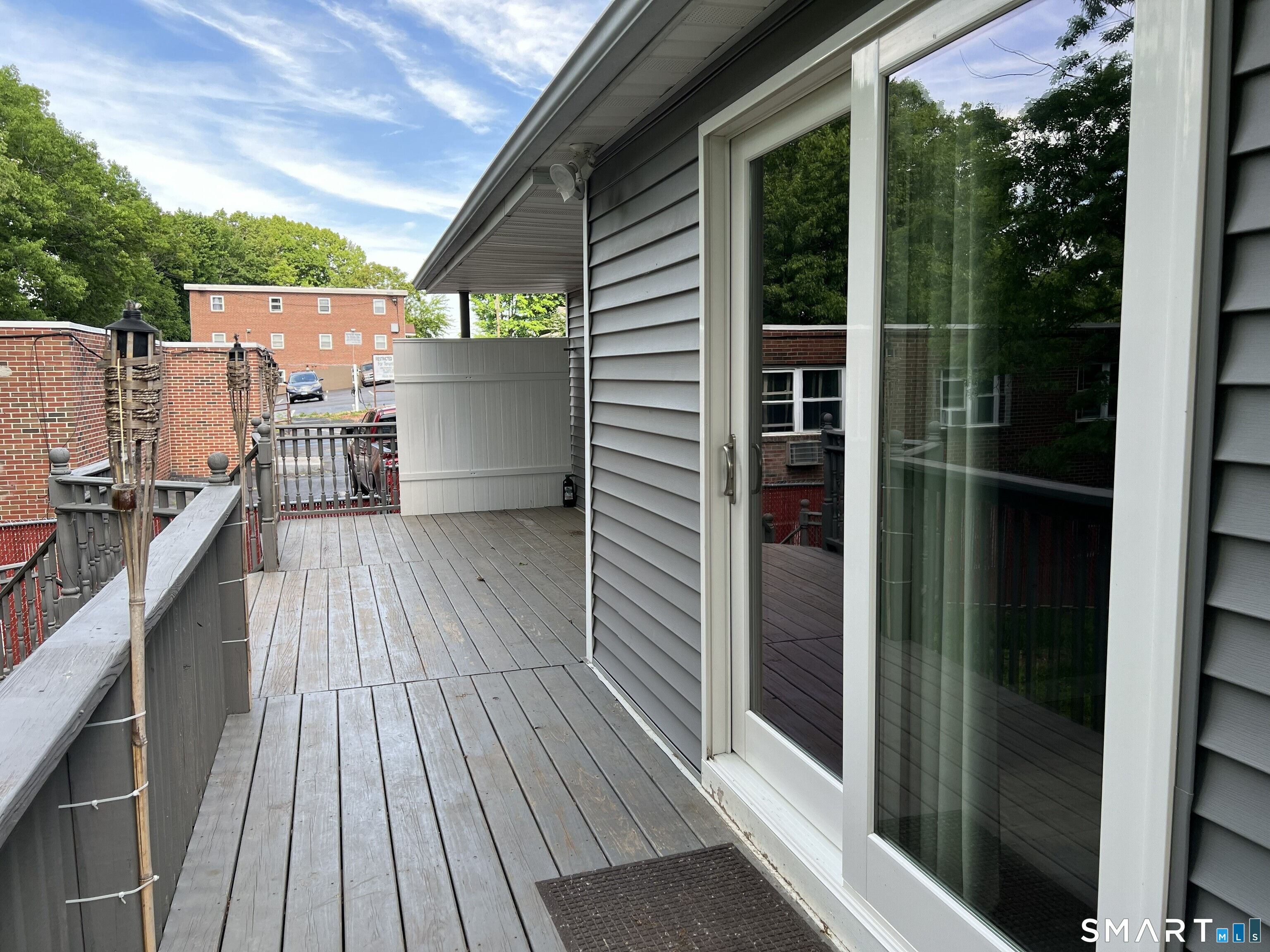 82 Bingham Street Bristol, CT 06010 - Photo 34 of 40 a view of a balcony with wooden floor and iron fence