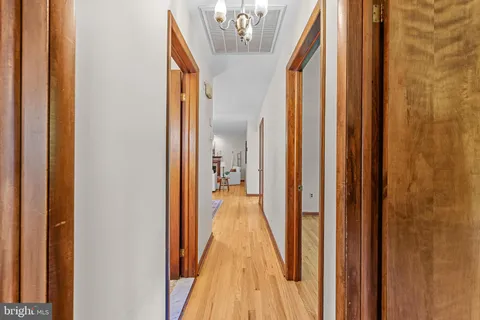 a view of a room with wooden floor and window