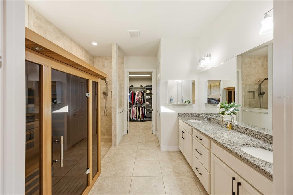 13349 Verandi Street Venice, FL 34293 - Photo 19 of 76 a large bathroom with a glass door shower and sink