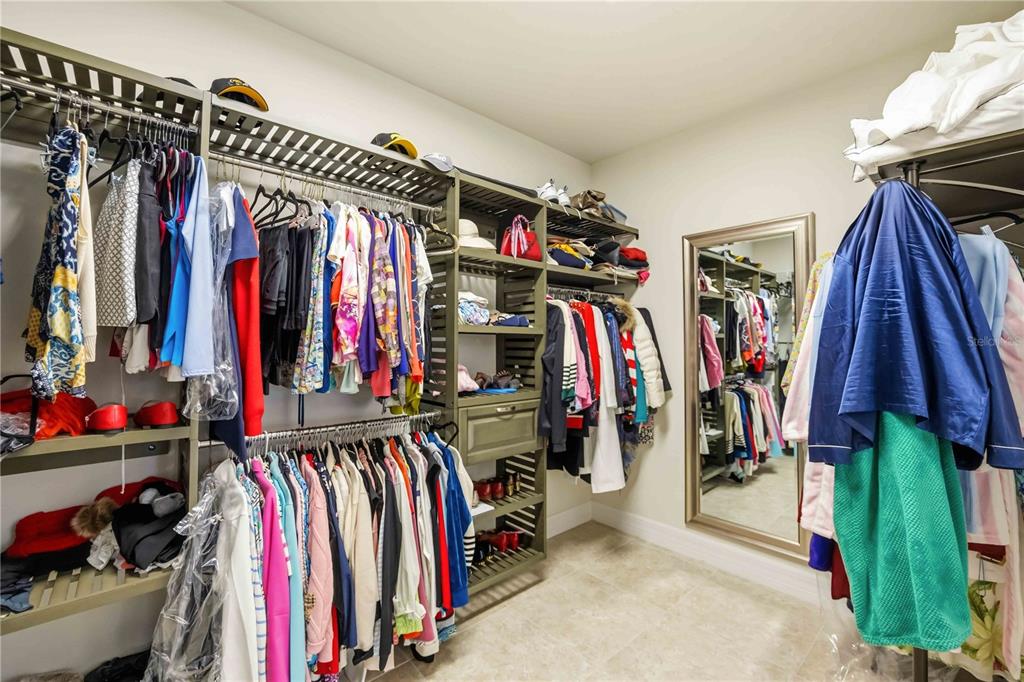 13349 Verandi Street Venice, FL 34293 - Photo 21 of 76 a view of walk in closet with clothes